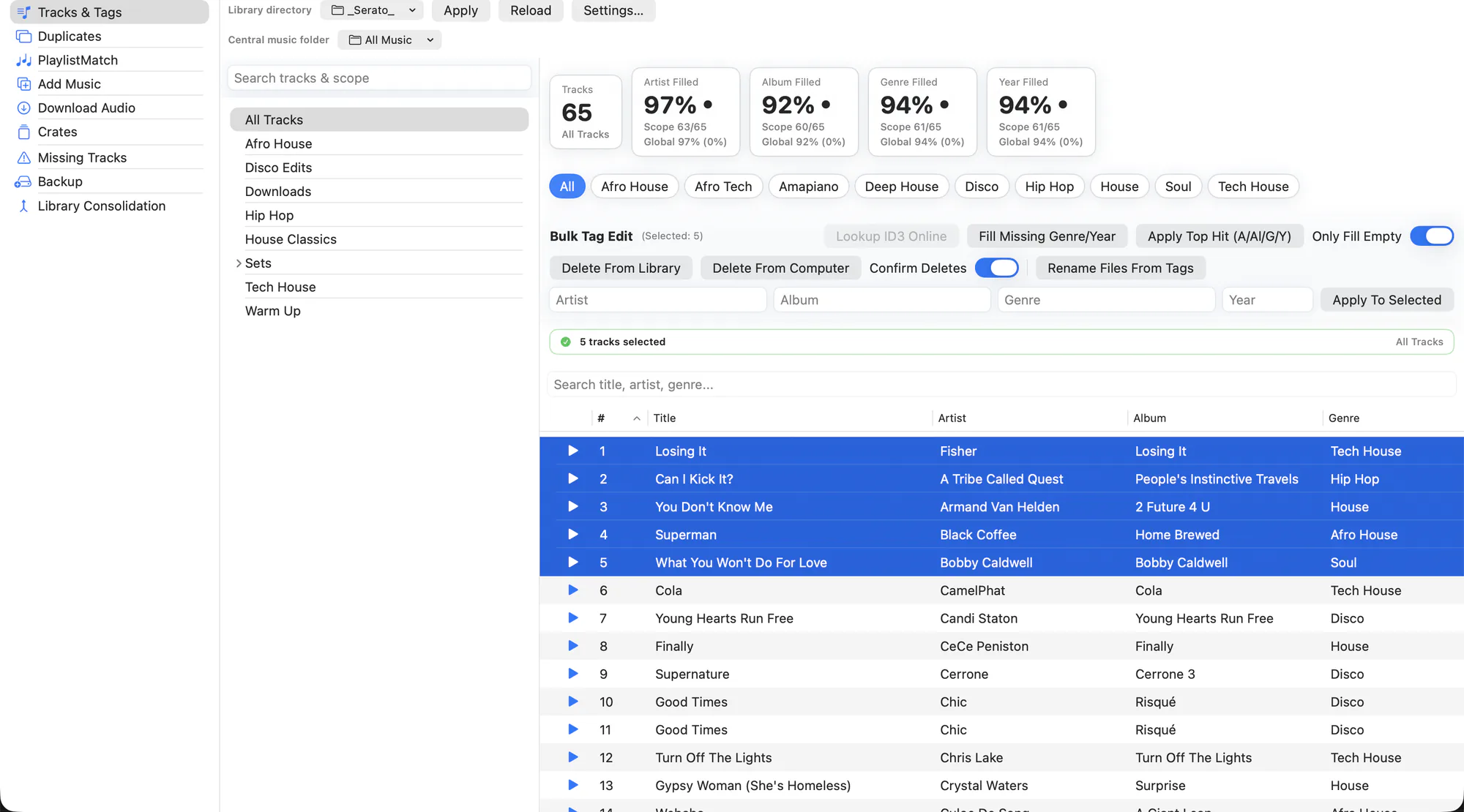 The EZLibrary Tracks and Tags window, showing a library table with artist, title, album, BPM and key columns, completion stats across the top, and a bulk edit bar.